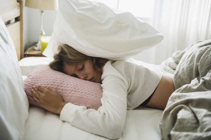 A Caucasian woman sleeping on her bed